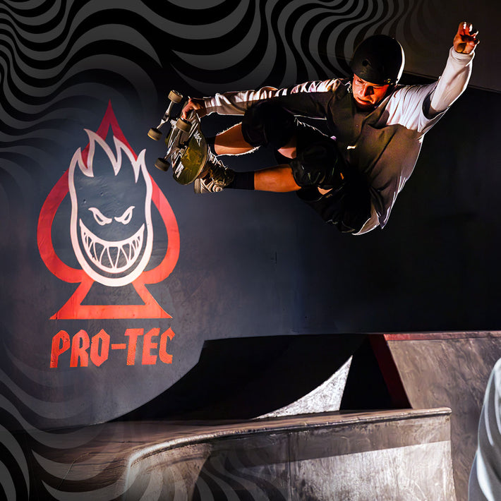 Skateboarder performing a trick with Pro-Tec x Spitfire logo in the background